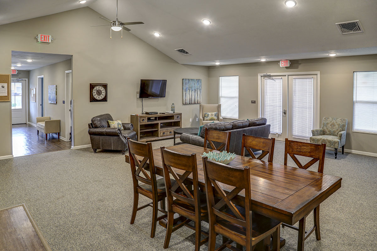 a living room and dining room with a table and chairs