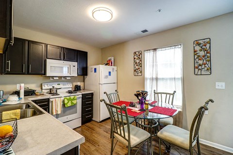 a kitchen and dining room with a table and chairs