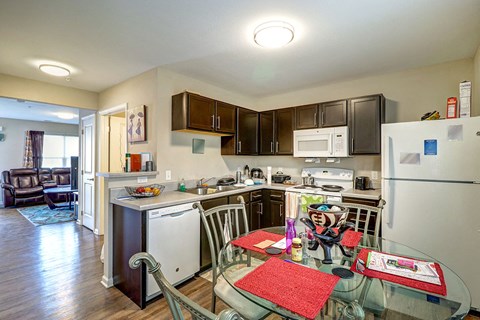 a kitchen and dining room with a glass table