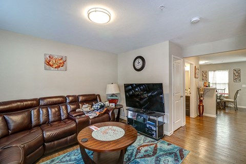 a living room with leather couches and a tv