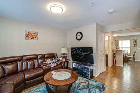 a living room with leather couches and a tv