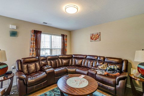 a living room with leather couches and a coffee table
