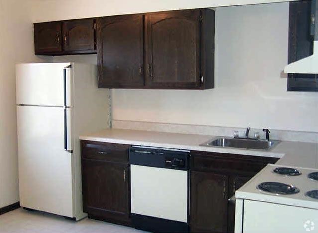 a kitchen with a white stove and a refrigerator