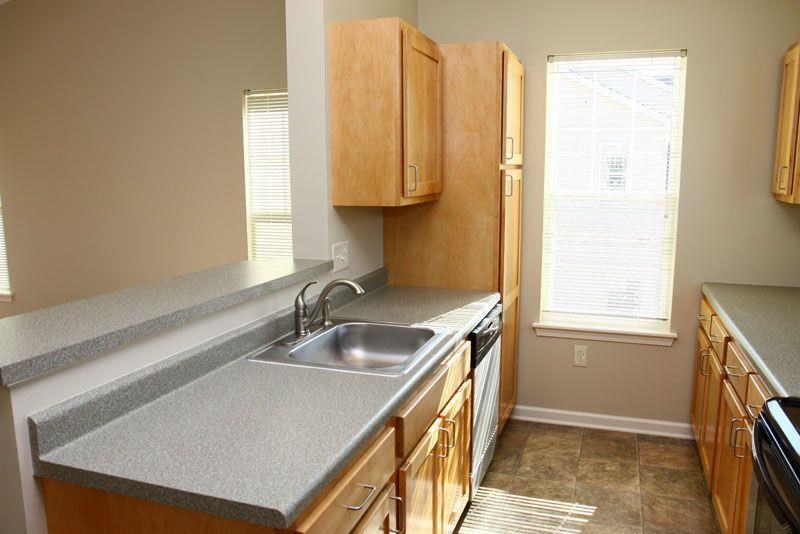 a kitchen with a sink and wooden cabinets