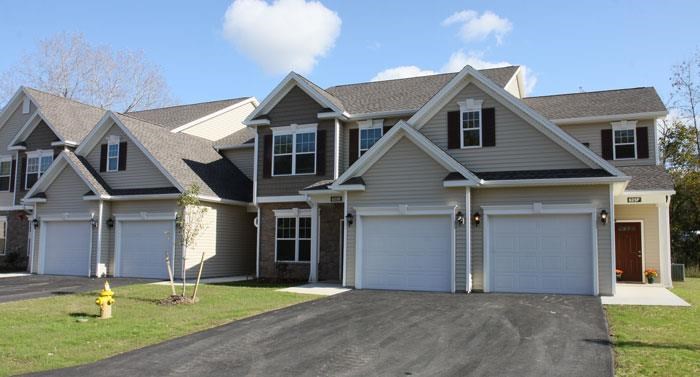 a house with two garage doors and a fire hydrant