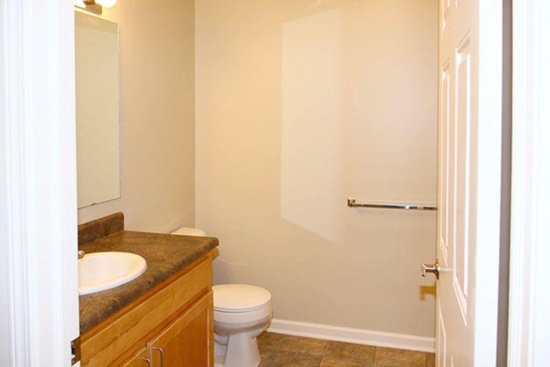 a bathroom with a toilet and a sink and a mirror