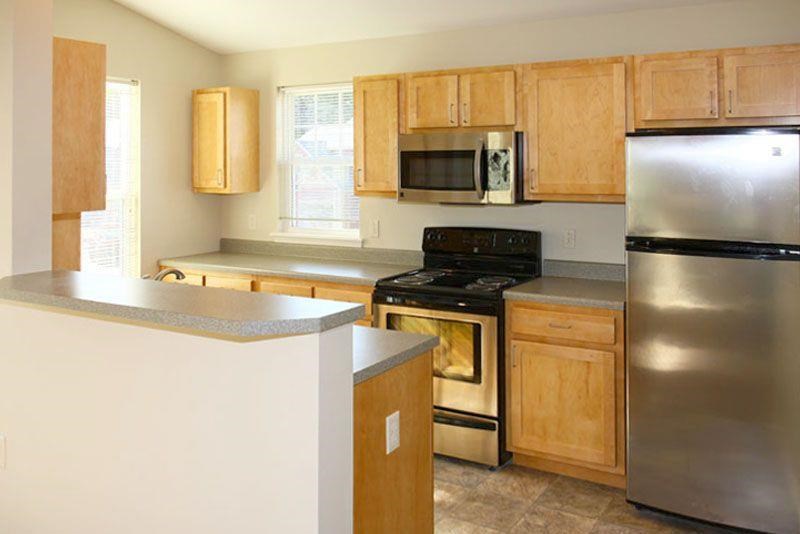 a kitchen with stainless steel appliances and wooden cabinets