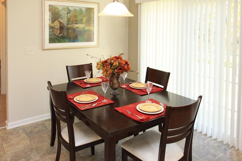 a dining room with a table and chairs