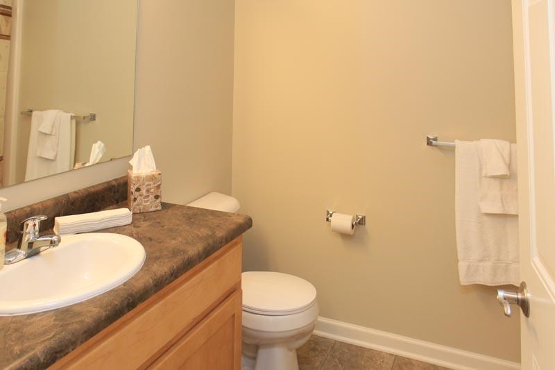 a bathroom with a toilet and a sink and a mirror