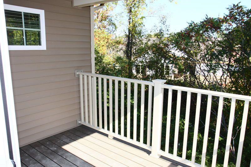 a balcony with a white railing and a window