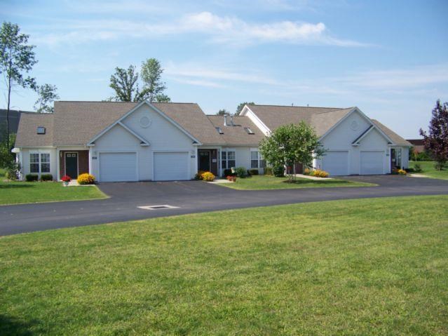a white house with a lawn in front of it