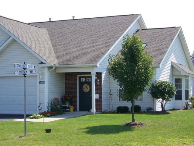 a white house with a street sign in front of it