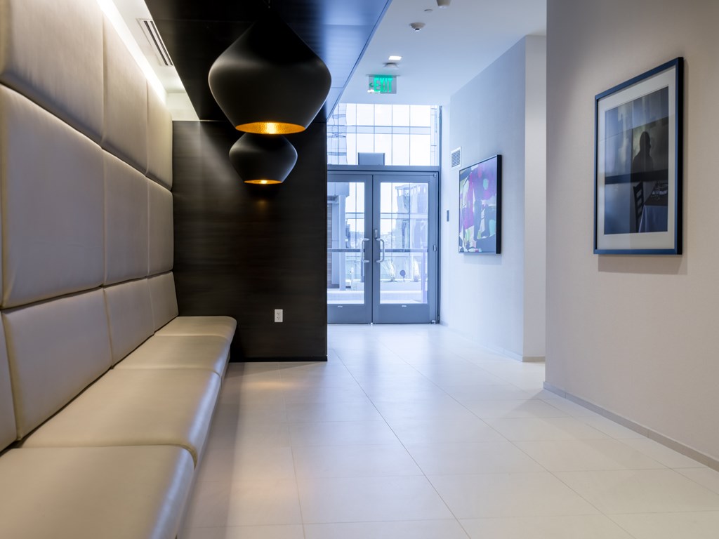 a corridor with a couch and a door in a building