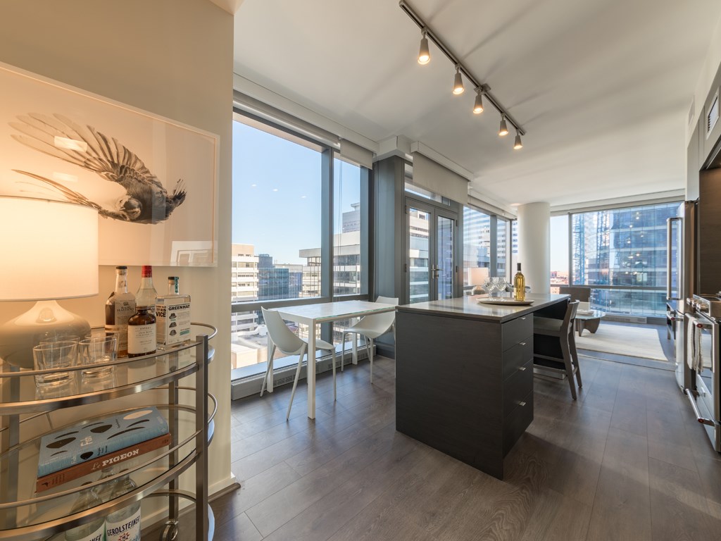 a kitchen and dining area with a large window and a city view