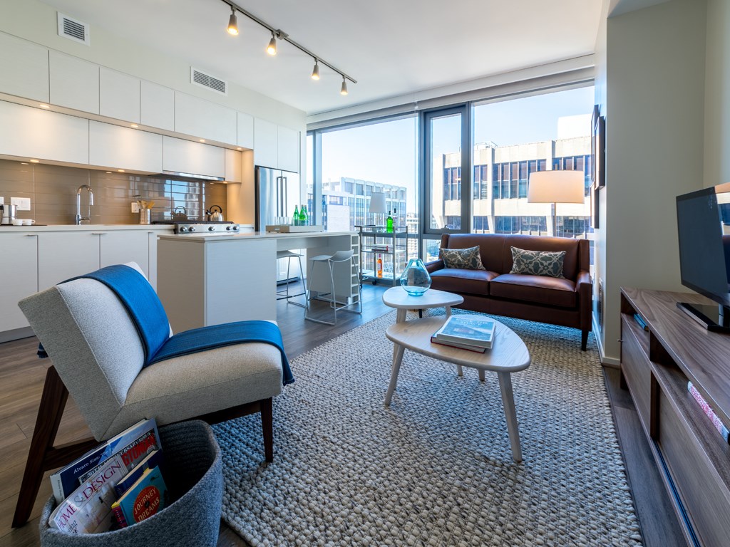 a living room with a kitchen and a couch and a table