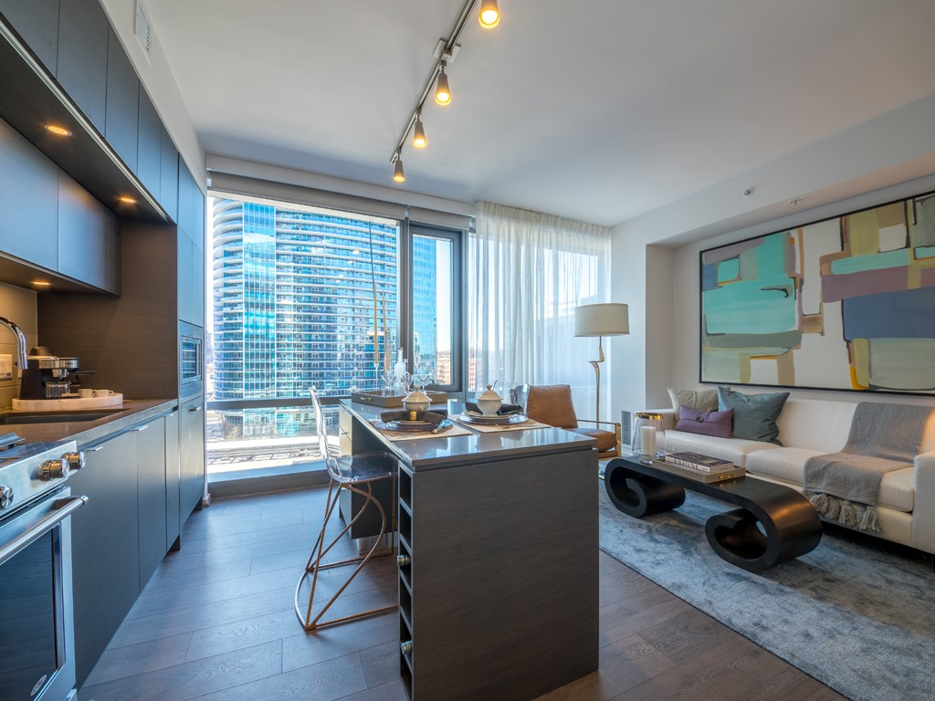 a kitchen and living room in a highrise apartment
