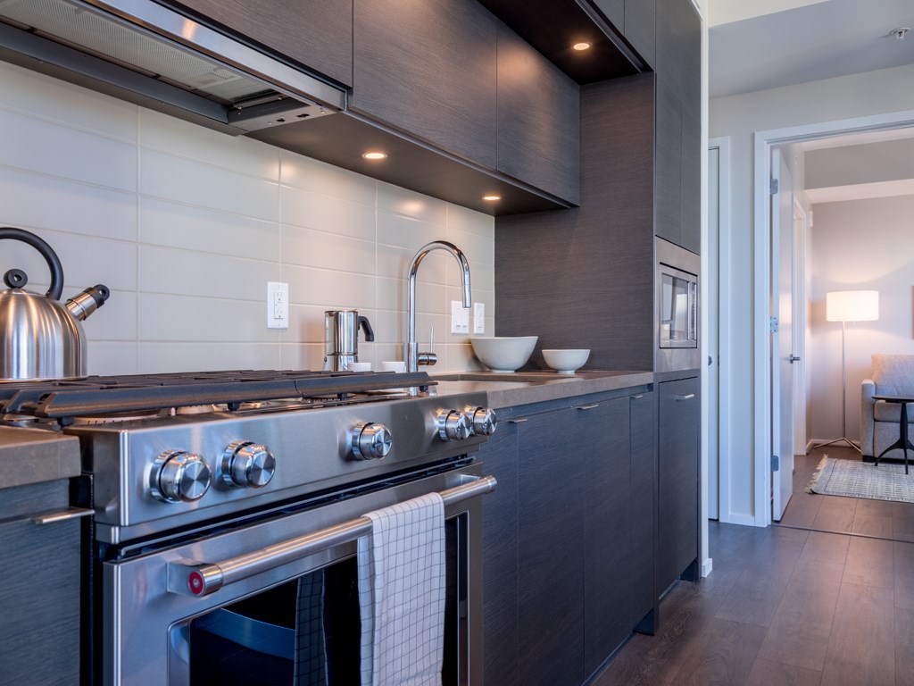 a kitchen with a stainless steel stove and a sink