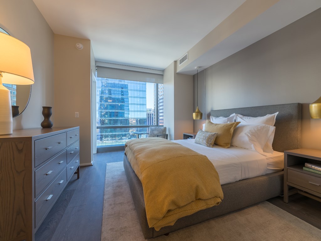 a bedroom with a large bed and a window