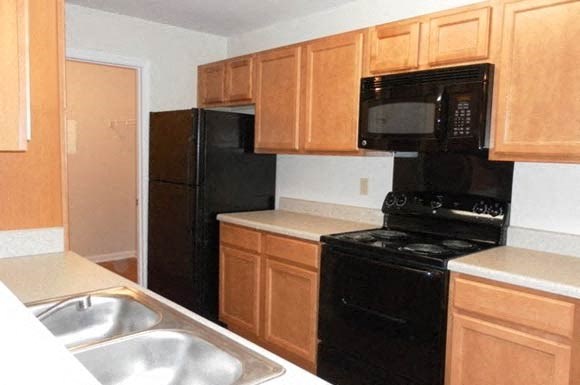 galley style kitchen with black appliances