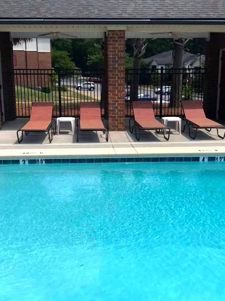 lounge furniture beside sparkling pool