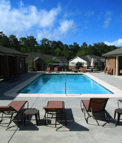 pool furniture by pool overlooking apartments