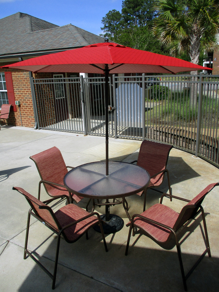new pool furniture with bright red umbrellas