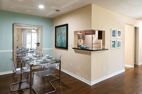 a dining room with a glass table and chairs
