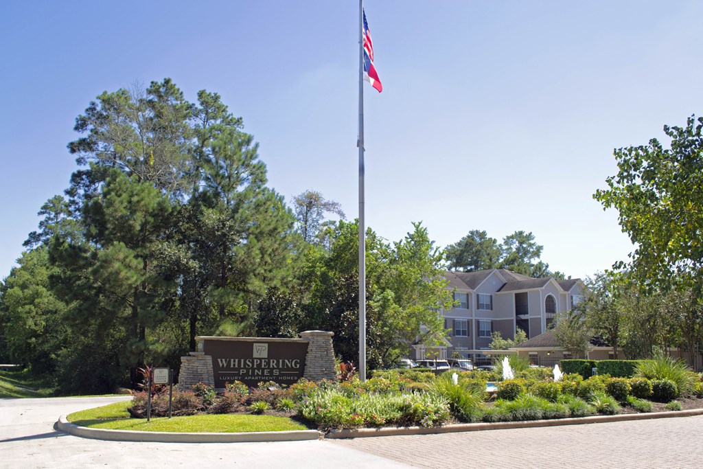 a flagpole with an flag in front of a building