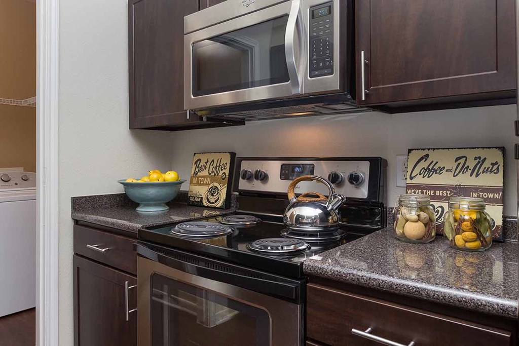 a kitchen with a stove and a microwave