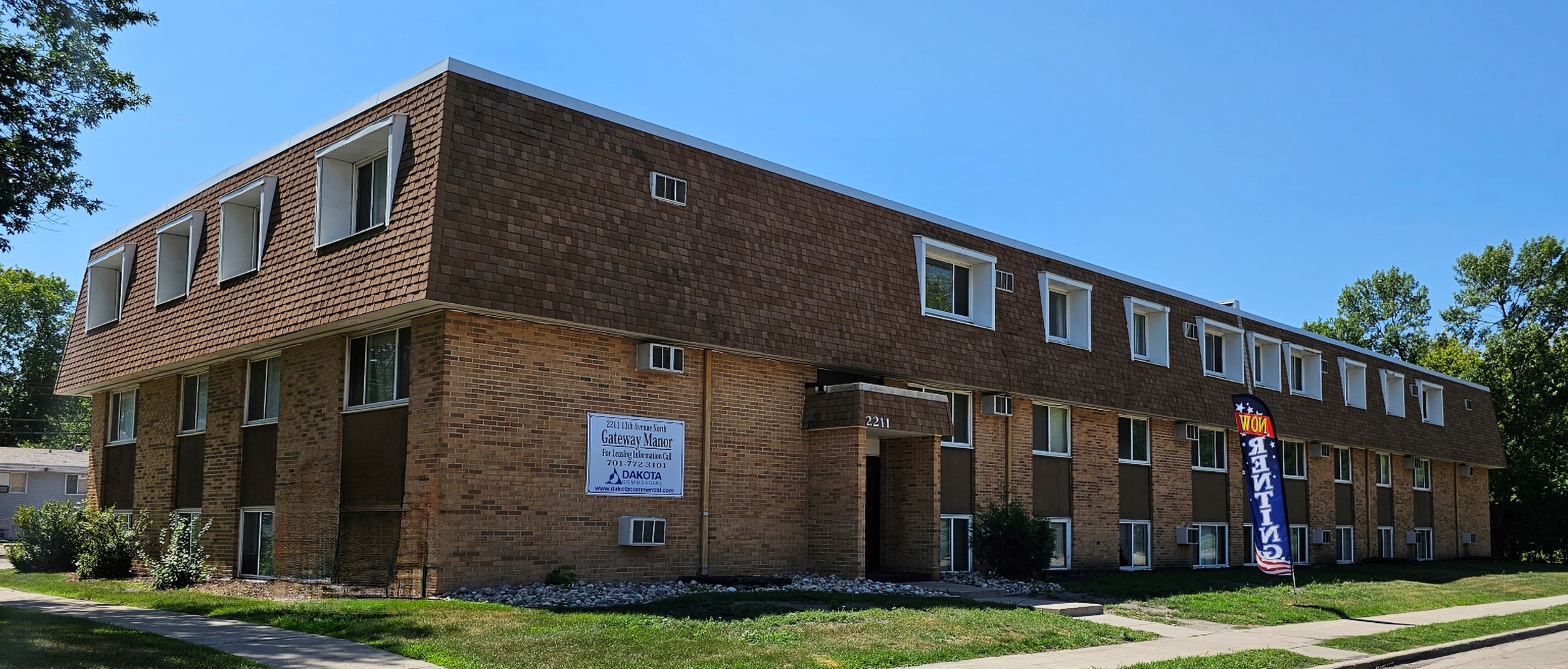 a brick building with a sign in front of it