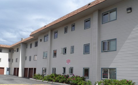 a white building with a red sign on the side of it
