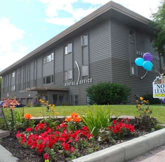 the front of the hilliard office building with flowers and plants