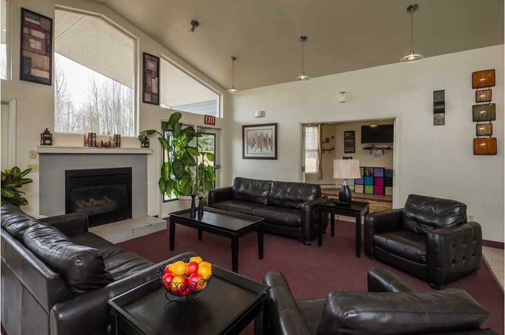 a living room with leather furniture and a fireplace