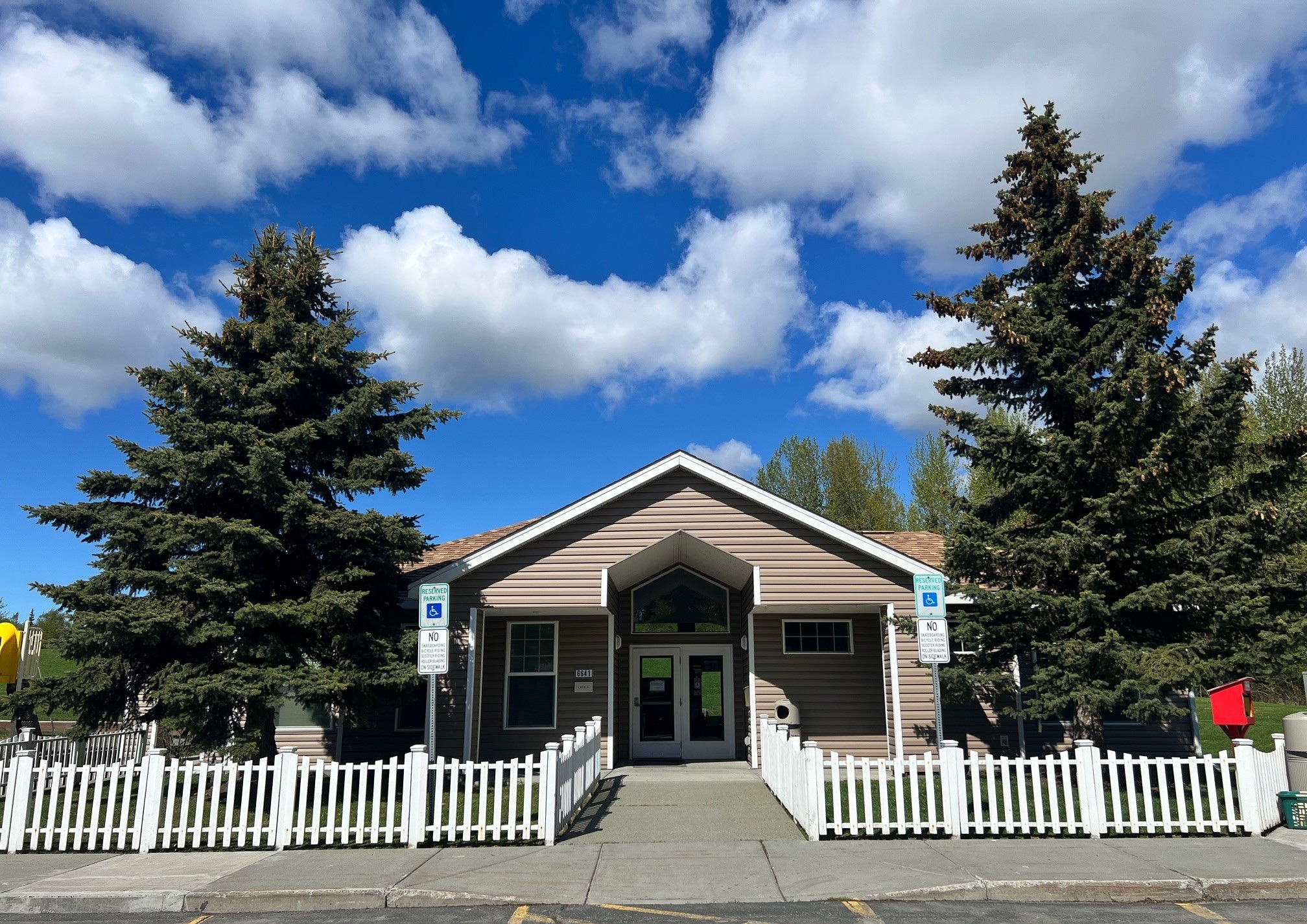A building with a white picket fence in front of it.