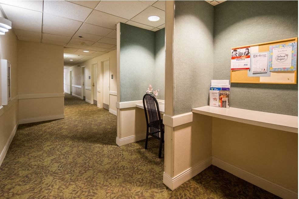 a empty room with a chair in a hallway