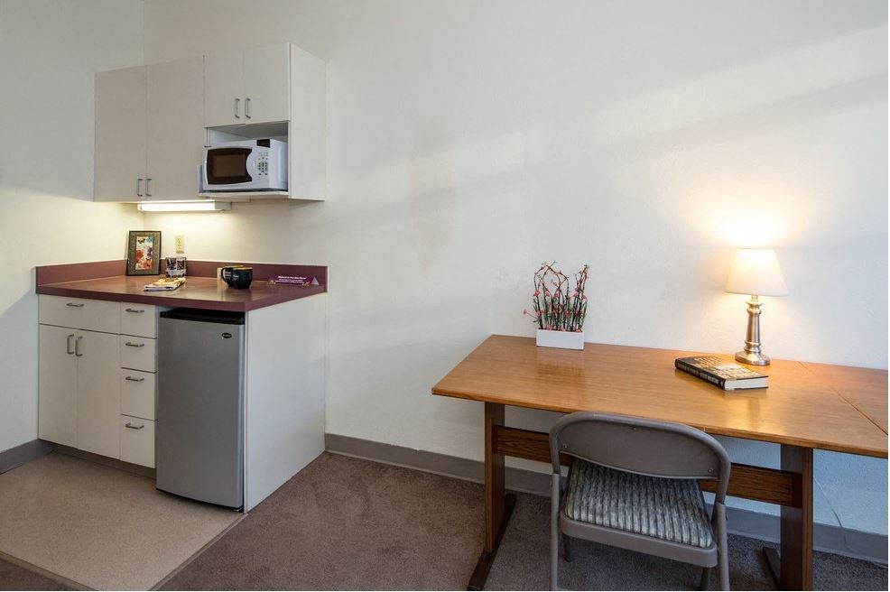 a small kitchen with a table and a microwave
