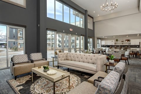 a living room with couches and chairs and a table