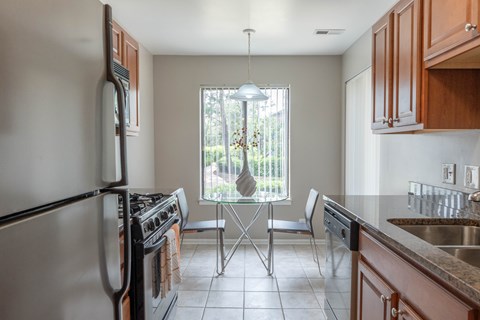 A kitchen with a stove top oven and a dishwasher.