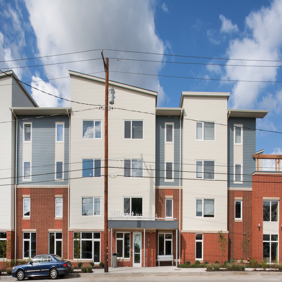 an apartment building with a car parked in front of it