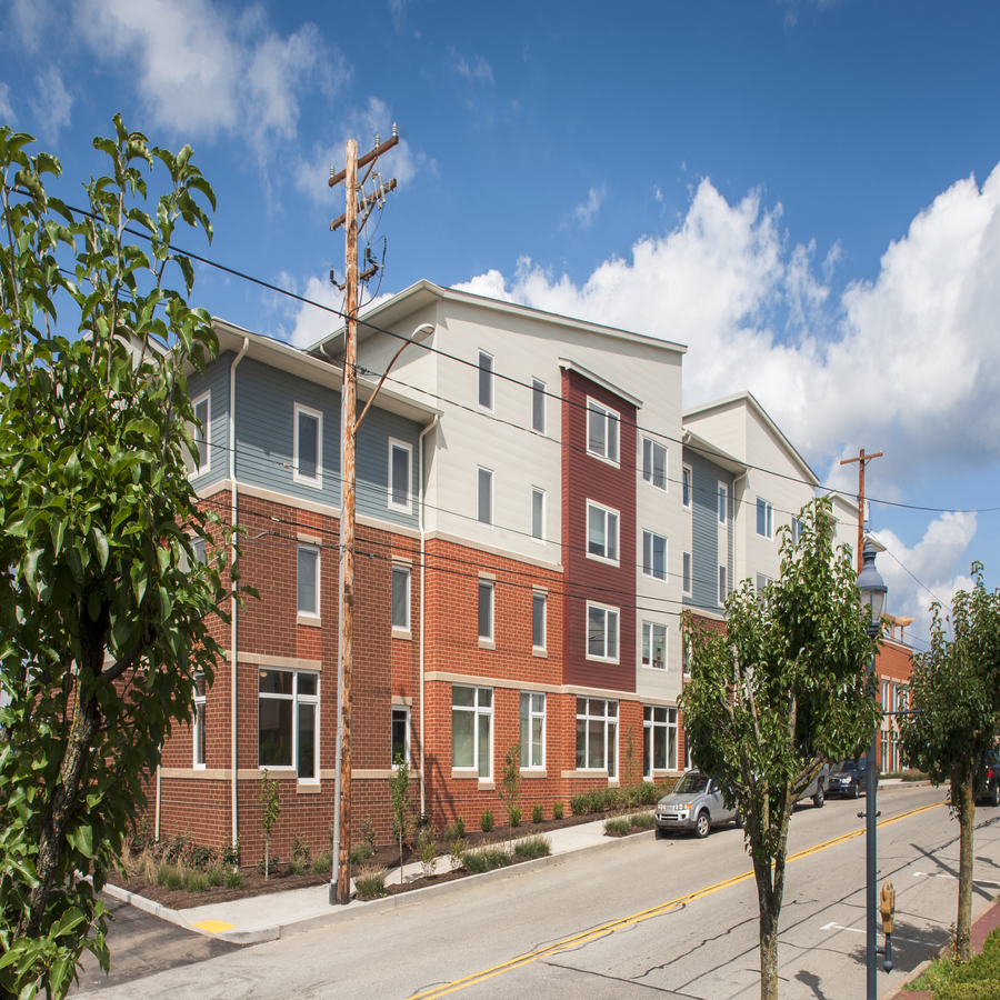 an apartment building on the corner of a city street