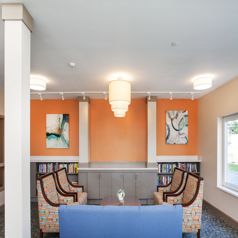 a living room with couches and chairs and a table