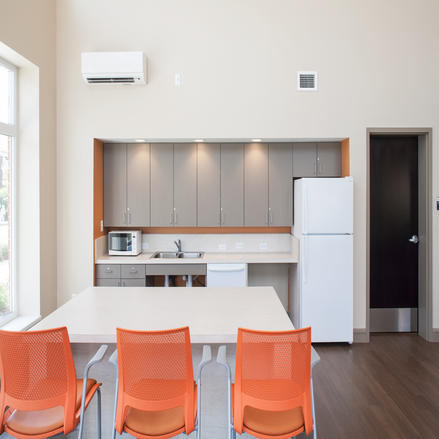 a kitchen and dining room with a white table and chairs