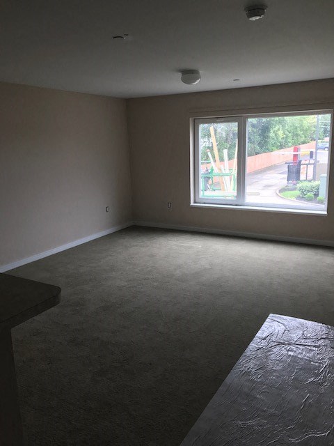 an empty living room with a large window