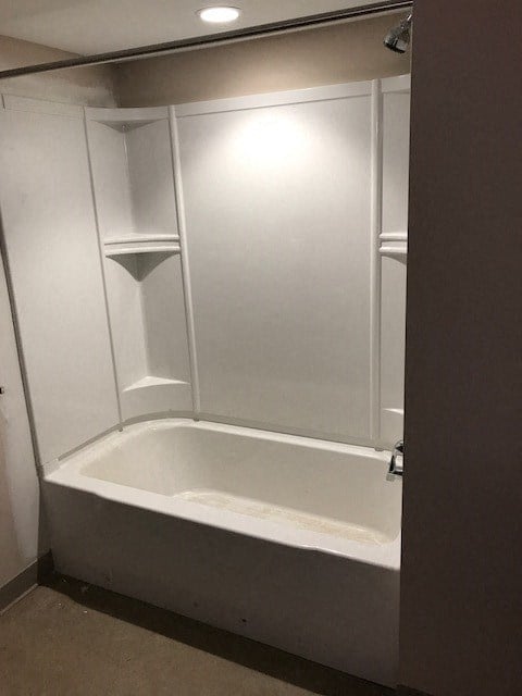 a small bathroom with a shower and a bath tub