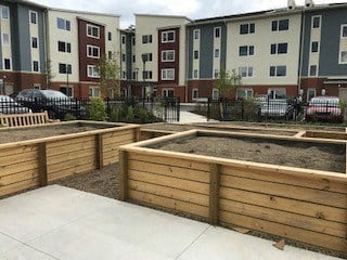 a community garden in front of an apartment building
