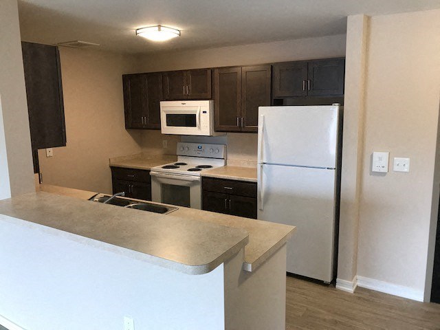 a kitchen with a stove and a refrigerator