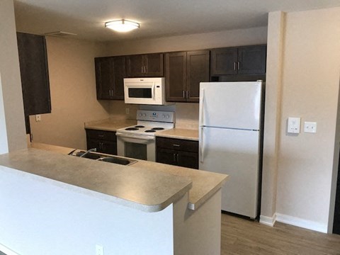 a kitchen with a stove and a refrigerator