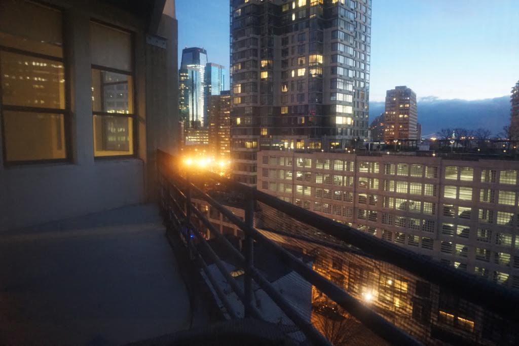 a balcony with a view of a city at night