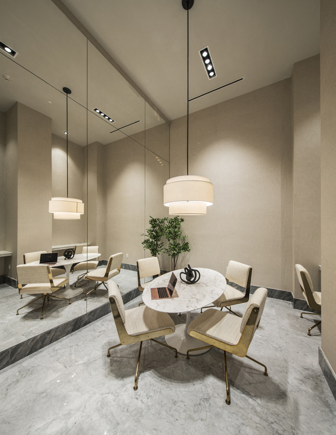 A modern dining room with a round table and chairs.