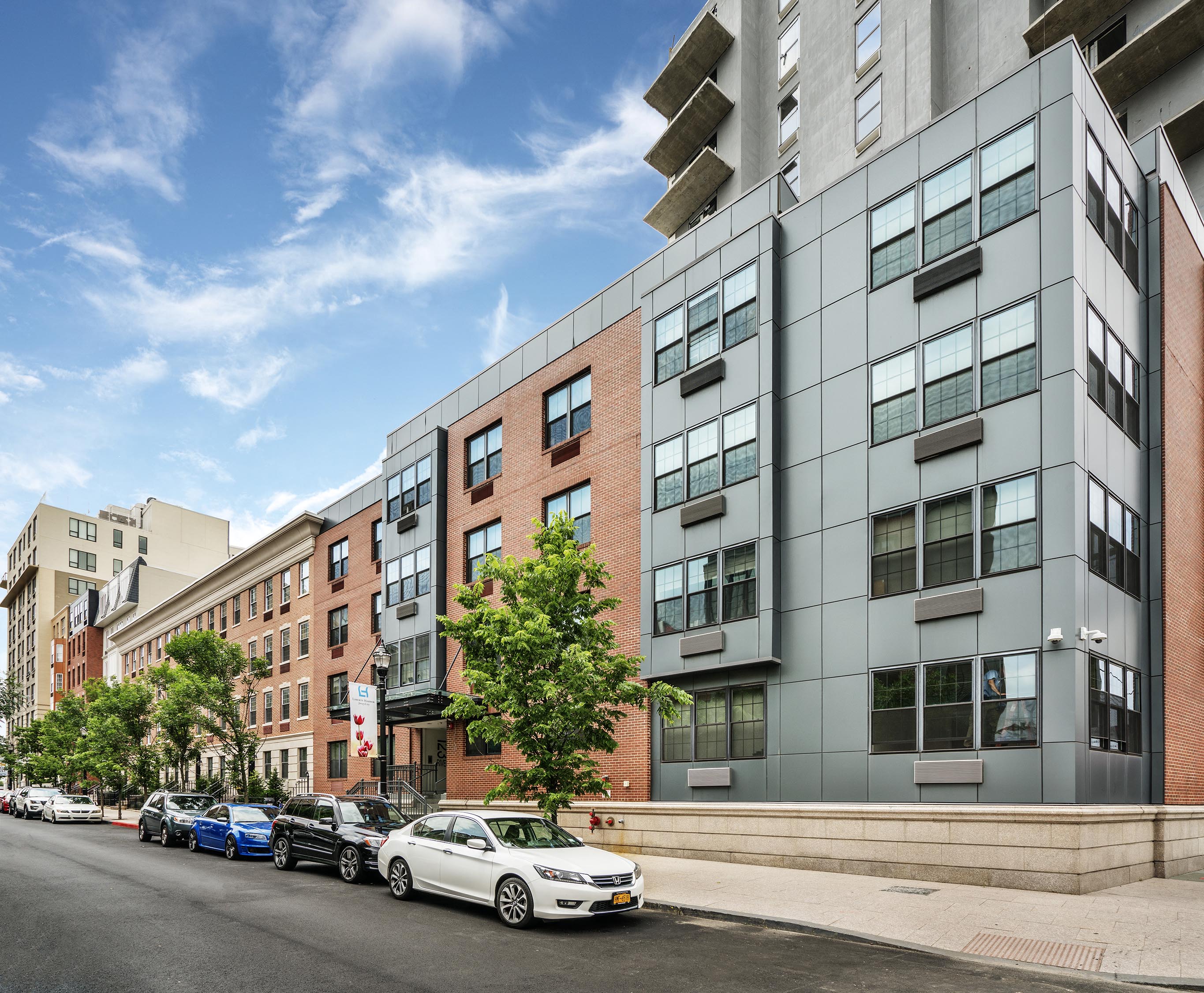 an apartment building on a city street with parked cars